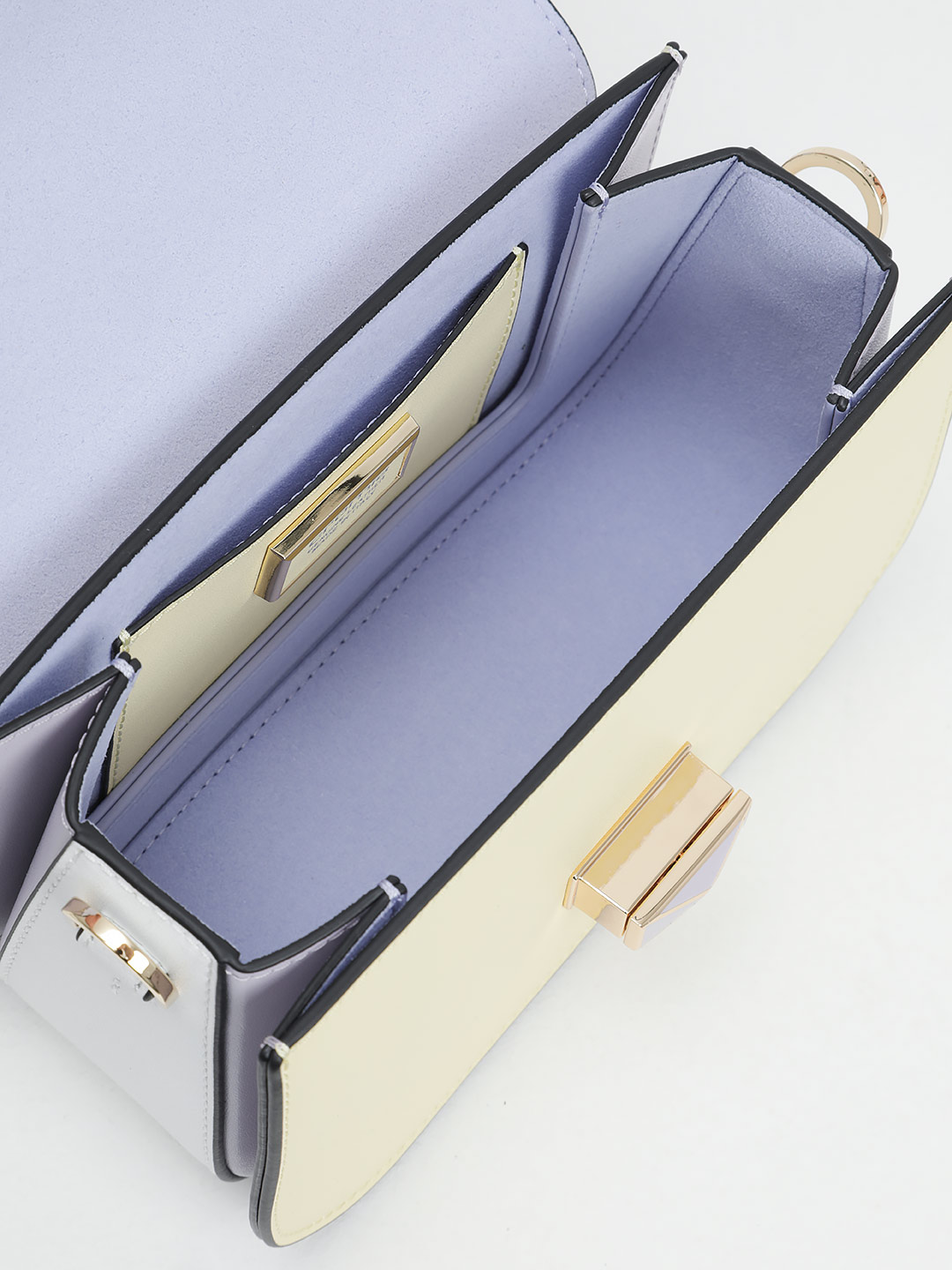 Маленькая сумка с поворотным замком на фирменной пряжке от Cromia из желтой и сиреневой кожи